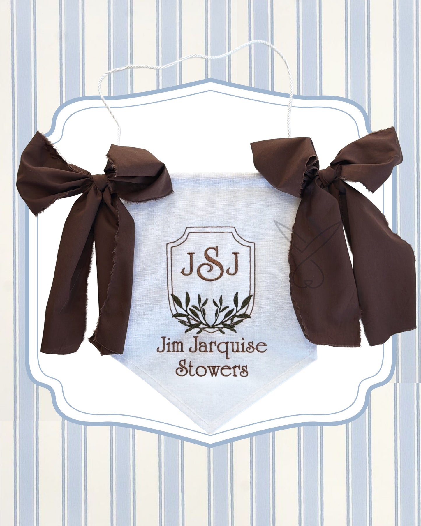Hanging sign with brown ribbons and 'JSJ Jim Jarquise Stowers' text on a striped background