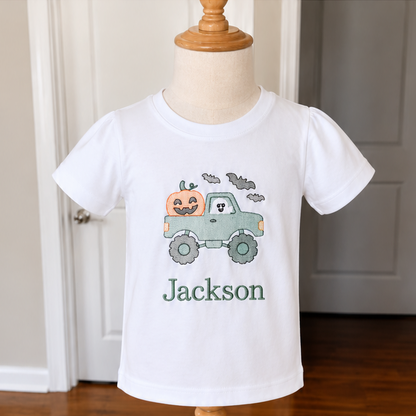 Three stacked views of a white short-sleeve T-shirt displayed on a wooden dress form. The shirt is personalized with the name 'Jackson' in blue and features different colorful space-themed graphics including planets, rockets, and a rocket with a pumpkin.